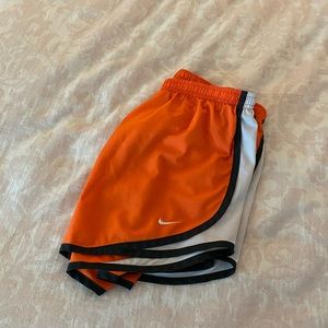 Orange Nike running shorts